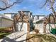 Inviting townhouse with brick accents, attached garage, and well-maintained landscaping under a bright blue sky at 6852 S Dover Way, Littleton, CO 80128