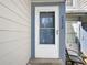 Close-up of the front door showing the house number, side light, and clean, modern design at 6852 S Dover Way, Littleton, CO 80128