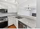 Updated kitchen featuring stainless steel appliances, modern countertops, and ample cabinet space at 6852 S Dover Way, Littleton, CO 80128