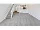 Open floor plan living room with staircase, view of the kitchen, and plenty of natural light at 6852 S Dover Way, Littleton, CO 80128