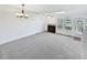 The living room features lots of natural light, a fireplace, new paint, and carpet at 6852 S Dover Way, Littleton, CO 80128