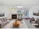 Inviting living room featuring a cozy fireplace, bright windows, and comfortable seating arrangement at 6852 S Dover Way, Littleton, CO 80128