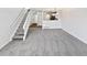 Open floor plan living room with staircase, view of the kitchen, and plenty of natural light at 6852 S Dover Way, Littleton, CO 80128