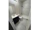Modern bathroom featuring marble tile, sleek vanity, and a shower-over-tub combination at 2280 S Jasper Way # A, Aurora, CO 80013