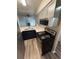 Modern kitchen featuring stainless steel appliances, light grey cabinets, and dark blue lower cabinets at 2280 S Jasper Way # A, Aurora, CO 80013