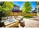 Backyard patio area with comfortable seating and overhead string lights, perfect for outdoor entertaining at 4970 Laurelglen Ln, Highlands Ranch, CO 80130