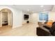 Finished basement with recessed lighting, wood flooring, a large window and a comfortable seating area with a TV at 4970 Laurelglen Ln, Highlands Ranch, CO 80130