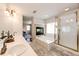 Bright bathroom features dual sinks, a soaking tub with fireplace, and a glass-enclosed shower at 4970 Laurelglen Ln, Highlands Ranch, CO 80130