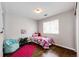 Bedroom with a window, hardwood floors, and light colored walls at 4970 Laurelglen Ln, Highlands Ranch, CO 80130