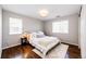 Bedroom with hardwood floors, light colored walls, and two windows at 4970 Laurelglen Ln, Highlands Ranch, CO 80130