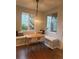 Cozy breakfast nook featuring built-in benches under bright windows and modern pendant lighting fixture overhead at 4970 Laurelglen Ln, Highlands Ranch, CO 80130