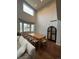 Dining room features a wooden table, high ceilings, and natural light at 4970 Laurelglen Ln, Highlands Ranch, CO 80130