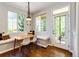 Cozy dining nook with built-in bench seating, a modern light fixture, and outdoor access to the backyard at 4970 Laurelglen Ln, Highlands Ranch, CO 80130