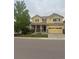 Charming two-story home with a welcoming front porch and a well-maintained lawn at 4970 Laurelglen Ln, Highlands Ranch, CO 80130