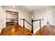 Hallway with hardwood floors and views to main bedroom at 4970 Laurelglen Ln, Highlands Ranch, CO 80130