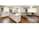 Modern kitchen with an island, quartz countertops, and hardwood floors at 4970 Laurelglen Ln, Highlands Ranch, CO 80130