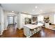 Modern kitchen showcasing a large island, stainless steel appliances, hardwood floors and open layout at 4970 Laurelglen Ln, Highlands Ranch, CO 80130