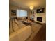 Inviting living room showcasing a plush sectional sofa, decorative fireplace, and a stylish round coffee table at 4970 Laurelglen Ln, Highlands Ranch, CO 80130