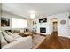 Comfortable living room with a large sectional sofa, fireplace, and built-in shelving for a modern and cozy feel at 4970 Laurelglen Ln, Highlands Ranch, CO 80130