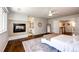 Spacious main bedroom with a fireplace, ensuite bathroom, hardwood floors, and ceiling fan at 4970 Laurelglen Ln, Highlands Ranch, CO 80130