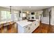 Open-concept layout showcasing the kitchen island, living room fireplace, and staircase to the second floor at 4970 Laurelglen Ln, Highlands Ranch, CO 80130