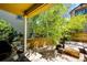 Beautifully landscaped outdoor patio area with grill, comfortable seating, and shade from mature trees at 4970 Laurelglen Ln, Highlands Ranch, CO 80130