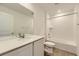 Bright bathroom featuring a vanity with quartz countertop and a tiled shower/tub combo at 22015 E 39Th Ave, Aurora, CO 80019