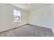 Bright and airy bedroom features neutral carpeting and a large window providing natural light at 22015 E 39Th Ave, Aurora, CO 80019