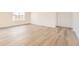Bright and airy bedroom featuring hardwood floors, a large window, and neutral paint, creating a serene atmosphere at 22015 E 39Th Ave, Aurora, CO 80019