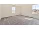 Well-lit bedroom with neutral carpeting, two large windows, and neutral paint, offering a cozy retreat at 22015 E 39Th Ave, Aurora, CO 80019