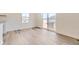 Sunlit dining area featuring hardwood floors, large windows, and sliding glass doors opening to the outdoors at 22015 E 39Th Ave, Aurora, CO 80019