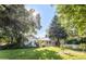 Spacious backyard with mature trees, garden beds, and a well-maintained lawn at 950 Everett St, Lakewood, CO 80215