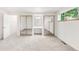 Bright bedroom with carpet, closet with mirrored sliding doors, and a large window overlooking backyard at 950 Everett St, Lakewood, CO 80215