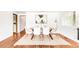 Bright dining room with seating for six and hardwood flooring at 950 Everett St, Lakewood, CO 80215
