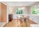 Dining area with glass table, modern lighting and large windows providing natural light at 950 Everett St, Lakewood, CO 80215