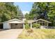 Charming single-story home with an attached carport and mature trees in a serene setting at 950 Everett St, Lakewood, CO 80215