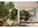 Covered porch with brick pillar, seating, and views of the landscaped front yard at 950 Everett St, Lakewood, CO 80215
