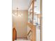 Hallway featuring pendant light, bookshelf and view into a living room at 950 Everett St, Lakewood, CO 80215
