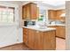 Cozy kitchen with skylight, wooden cabinets and white countertops at 950 Everett St, Lakewood, CO 80215