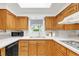 Traditional kitchen with wood cabinets, white countertops, and stainless steel appliances at 950 Everett St, Lakewood, CO 80215