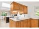 Well lit kitchen featuring wood cabinetry, white countertop and backsplash, and stainless steel sink at 950 Everett St, Lakewood, CO 80215
