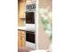 Kitchen detail of stainless steel double oven and shaker-style wood cabinets at 950 Everett St, Lakewood, CO 80215