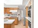Efficient and clean kitchen with natural wood cabinets and stainless steel appliances at 950 Everett St, Lakewood, CO 80215