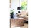Cozy living room with textured coffee table, modern decor, and a view to lush backyard at 950 Everett St, Lakewood, CO 80215