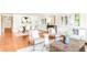 Open-concept living room with dining area, hardwood floors, and bright white walls at 950 Everett St, Lakewood, CO 80215
