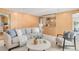 Comfortable living room with wood paneling, stylish furniture, and lots of natural light at 950 Everett St, Lakewood, CO 80215