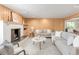 Bright living room with fireplace, wood paneling, plush furniture, and elegant decor at 950 Everett St, Lakewood, CO 80215