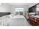 Bright bedroom featuring large windows, a bed, a changing table and a view of the neighborhood at 10031 Town Ridge Ln, Lone Tree, CO 80124