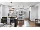 Modern kitchen boasts white cabinets, stainless steel appliances, and an island with stone countertop at 10031 Town Ridge Ln, Lone Tree, CO 80124