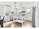 Bright kitchen with white cabinets, stainless steel appliances, island, and hardwood floors at 10031 Town Ridge Ln, Lone Tree, CO 80124